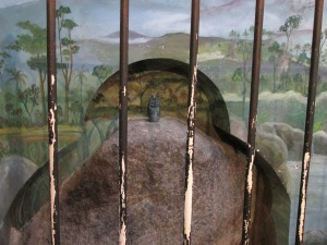 Behind metal bars sits the stone where Juana Pereira originally found La Negrita.