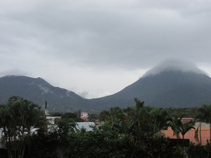 Volcán Arenal (right) looms outside our hotel, the summit frosted with clouds.